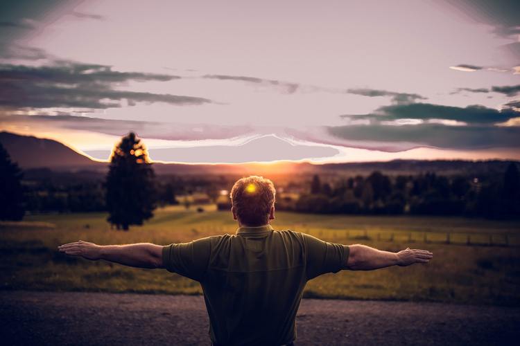 man stretching at sunset