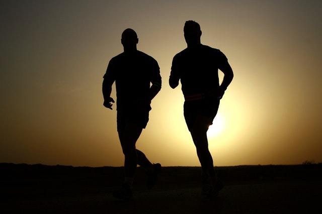 two men running at sunrise